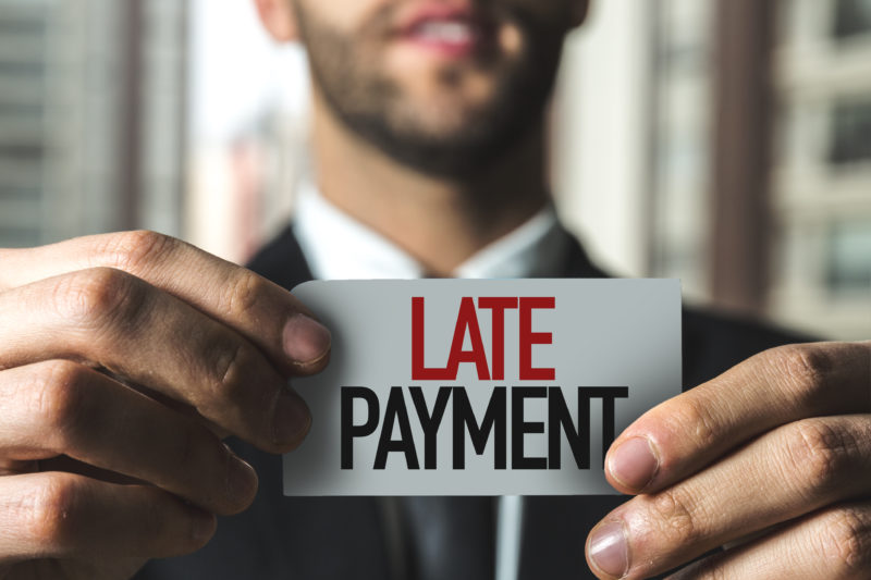 holding sign | late rent payments